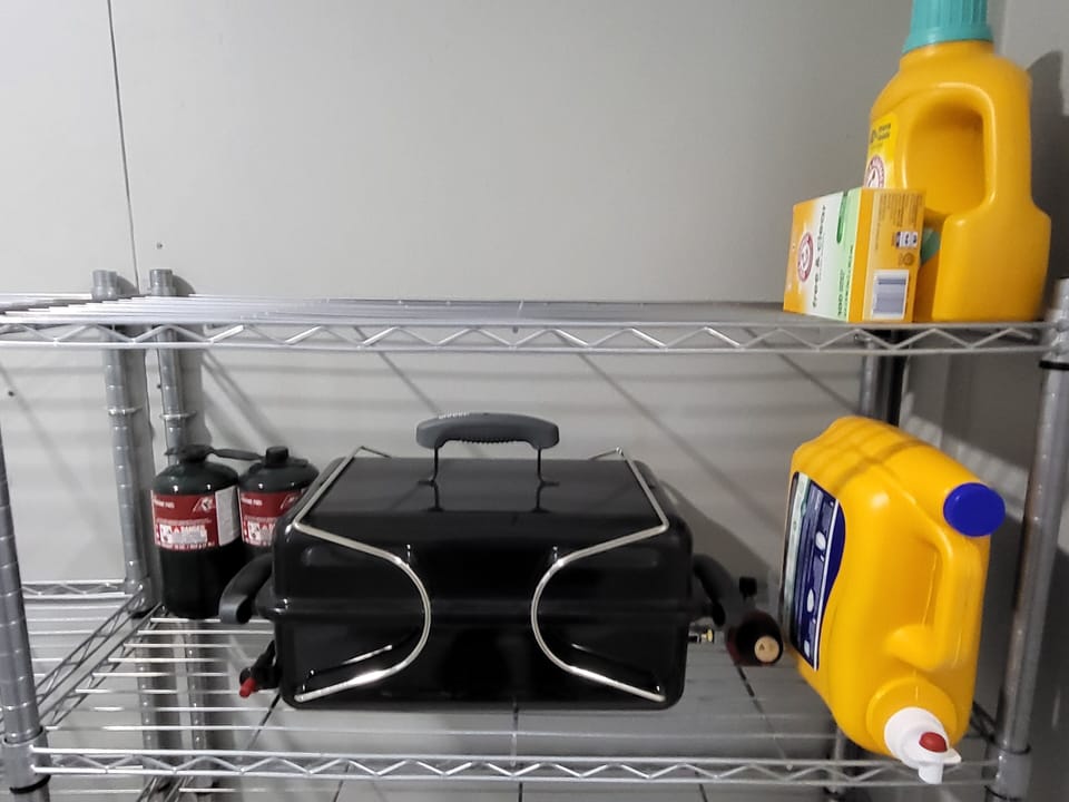 Small propane BBQ grill and complimentary laundry soap.