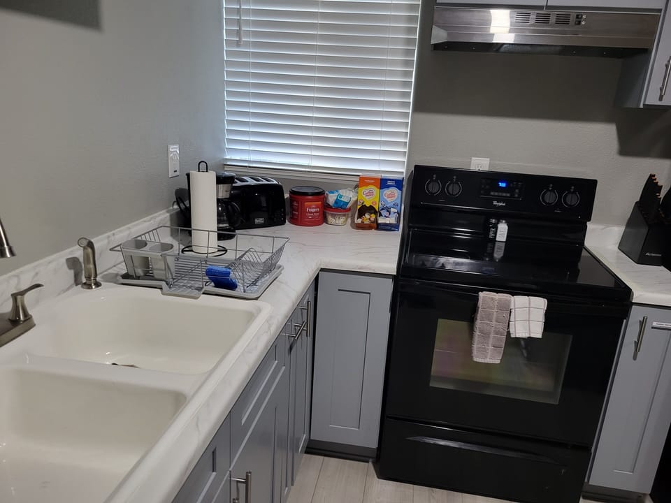 Full range and oven, deep double sink, toaster, and coffee bar