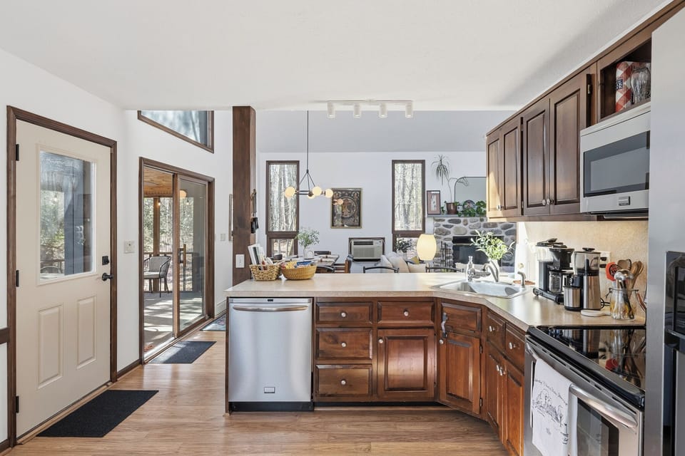 Bright kitchen with stainless steel appliances, ample counter space, and a cozy breakfast nook by the window.