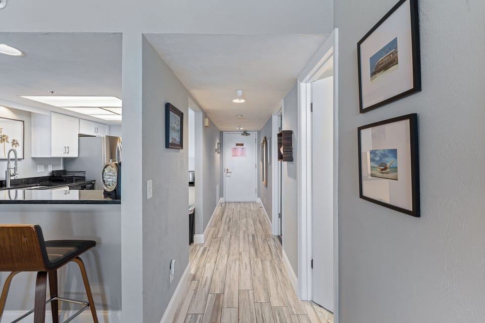 Main hallway, looking at entrance door with kitchen off to the left