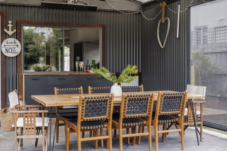 Undercover outdoor area with heaters, fan, pull down blinds and mini fridge