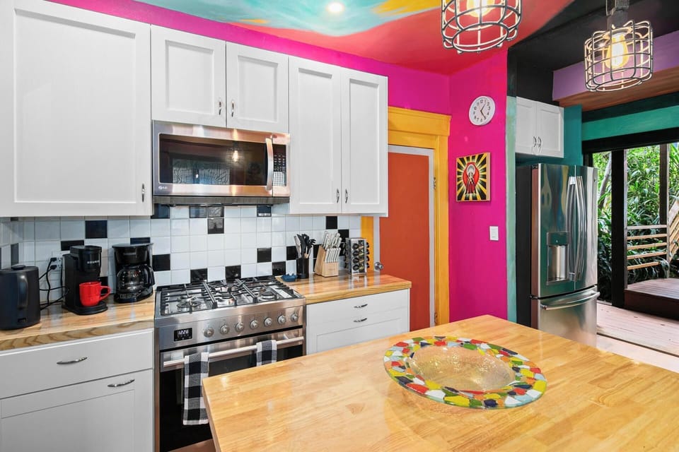Fully equipped kitchen with ample counter space and a pop of color to match the home's creative energy.
