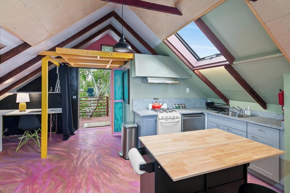 Bright full kitchen with modern appliances, gas stove, and natural light.