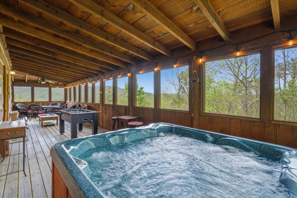 Unwind in your private hot tub while enjoying panoramic mountain views from this screened porch, complete with games for endless entertainment.