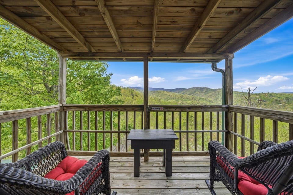 Your private mountain retreat awaits with plush seating and sweeping forest views that stretch endlessly before you.