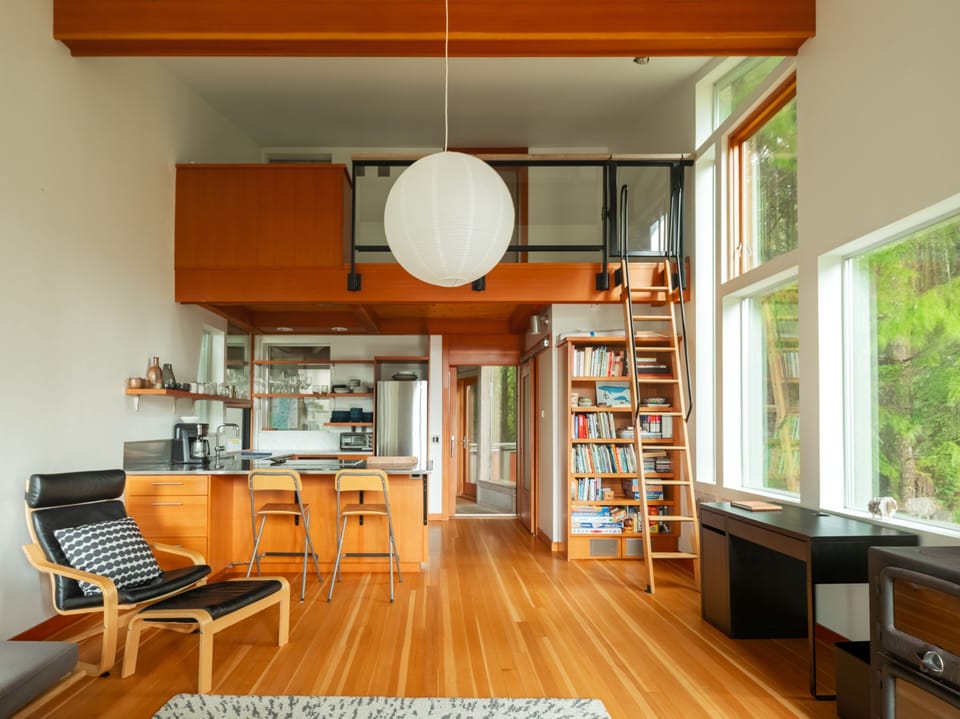 Unwind in this stunning open-plan space where warm wood meets modern design. Cook, read, or work surrounded by natural light and forest views.