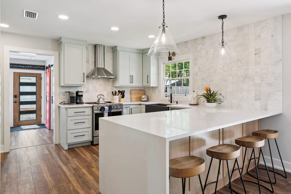 Your fully equipped modern kitchen features a spacious island with bar seating, perfect for morning coffee or casual meals together.
