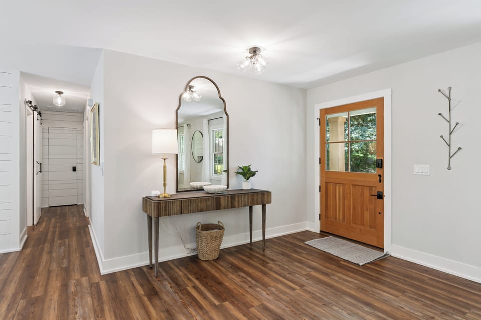 You'll love this welcoming entryway with its warm wood floors and stylish console table—perfect for setting down your keys.