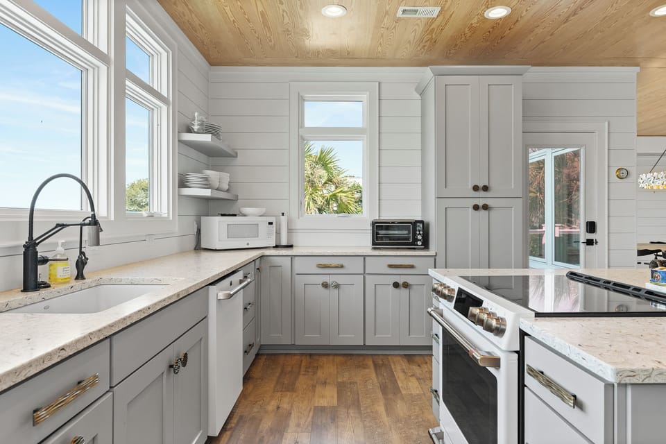 Cook memorable meals in your bright, modern kitchen with granite counters and charming wood ceiling.