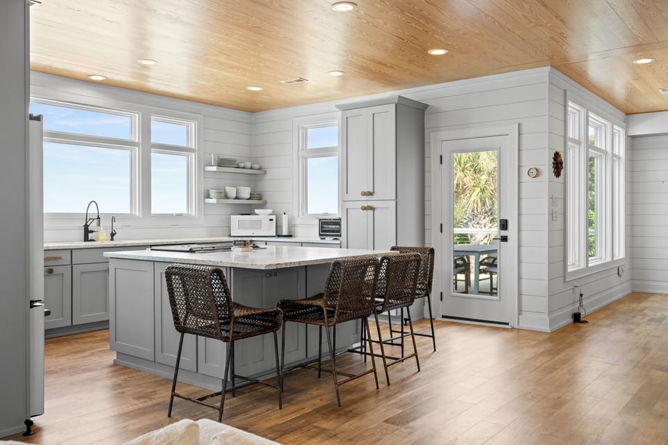 Cook together in your modern kitchen island with ocean views streaming through expansive windows.