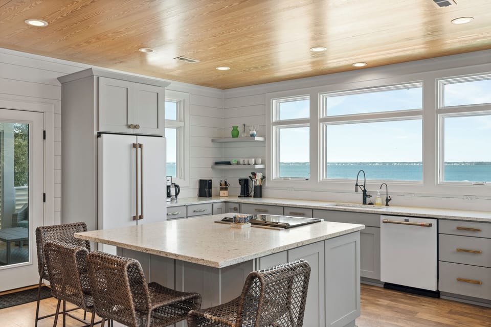 Your dream kitchen awaits with stunning water views, modern appliances, and a spacious island perfect for morning coffee or evening meals.