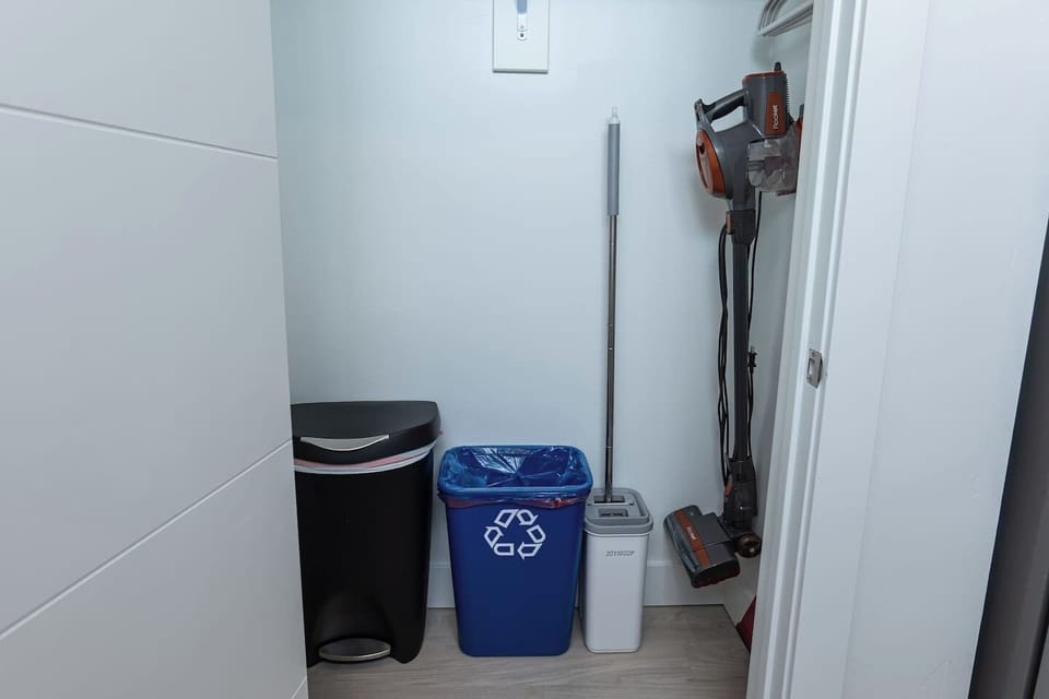 Cleaning supplies. Vacuum, Mop, Recycle and Trash bins