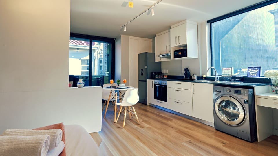 Equipped kitchen with dining space, in-unit washer and full-size fridge