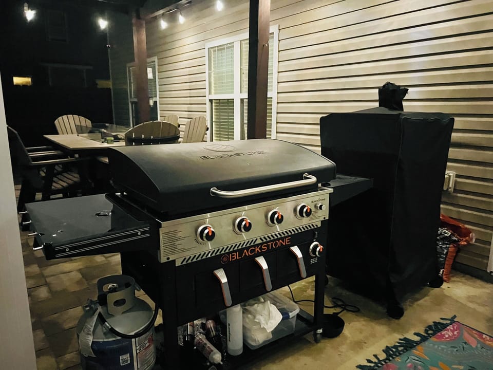 Fire up the Blackstone grill for your perfect outdoor feast under twinkling patio lights.
