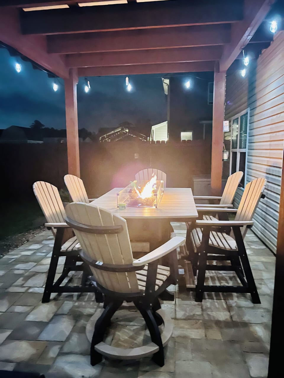 Gather around your private fire pit table where cozy evenings unfold under twinkling lights and starlit skies.