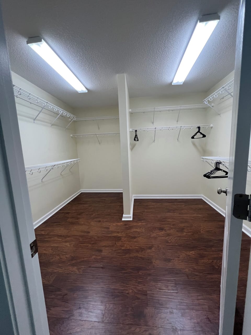 Your spacious walk-in closet offers plenty of room to organize your belongings with adjustable shelving and hanging space.
