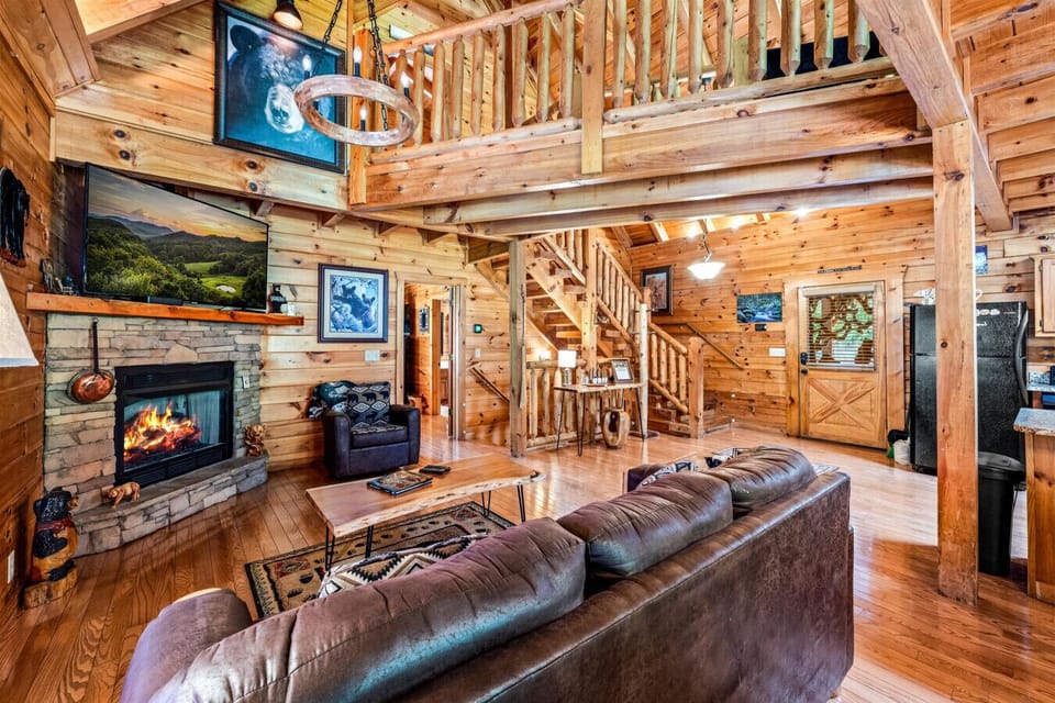 The warm wood interiors, vaulted ceilings, and open gathering spaces capture everything guests love about a classic Smoky Mountain cabin experience.