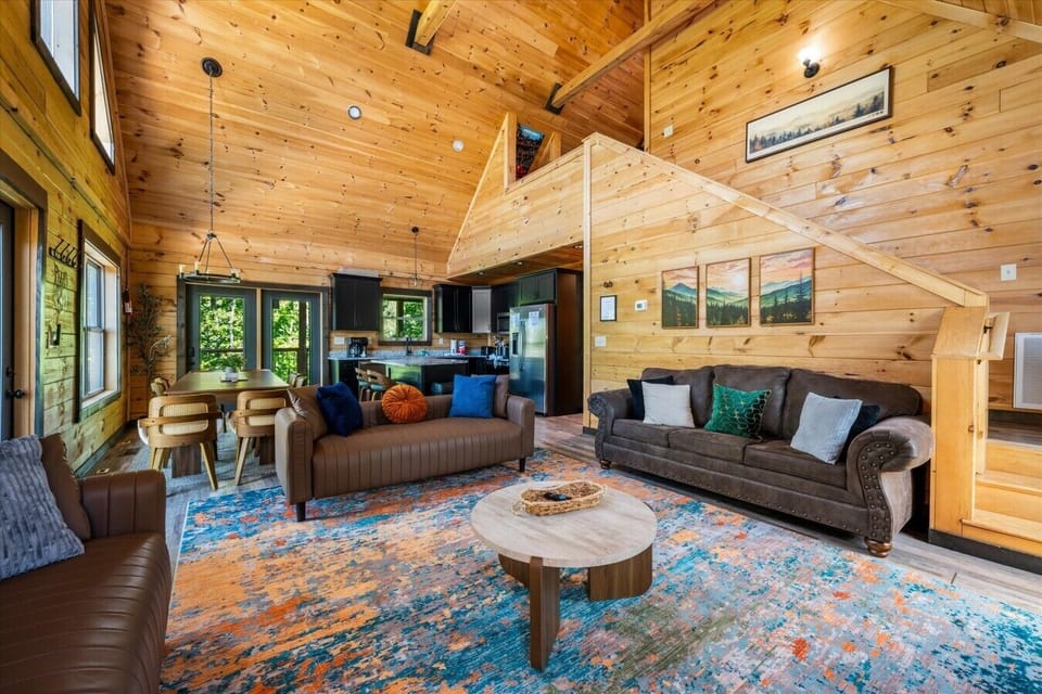 This open-concept living area connects the kitchen, dining space, and loft while providing plenty of room for relaxing and entertaining.