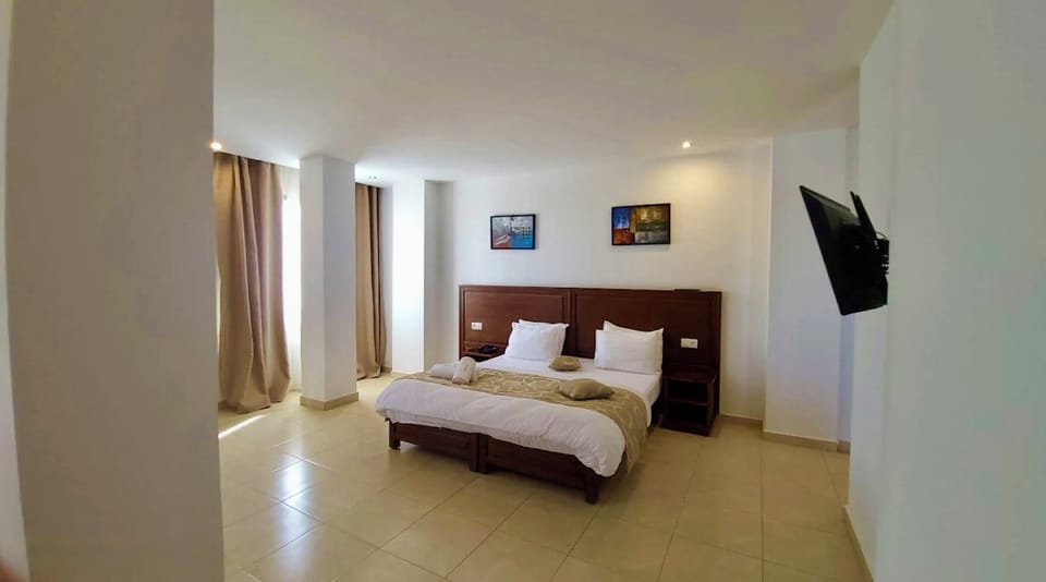 Double or Twin Room, City View | Desk, laptop workspace, WiFi (free), bed sheets