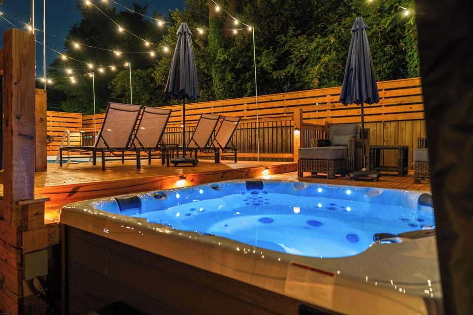 Relax in the brand new 2026 MasterSpa private hot tub under string lights, ideal
