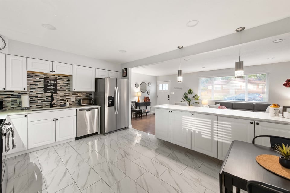 View of kitchen from back looking towards front of house.