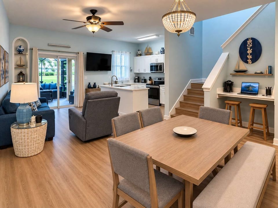 Gather together in this spacious, open-concept living and dining area. Featuring comfortable coastal-inspired seating, a dining table for group meals, and beautiful natural light.