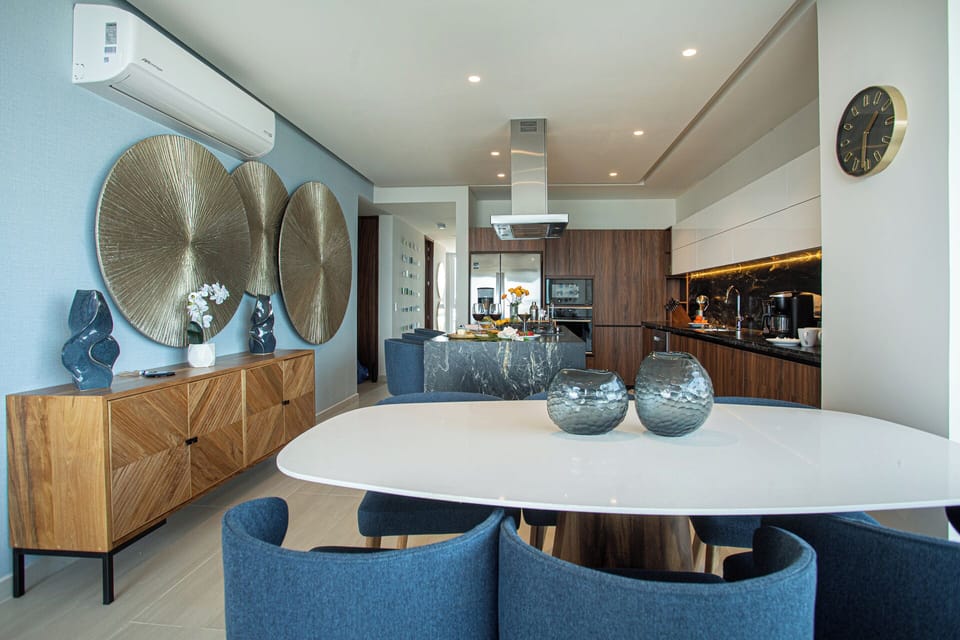 Dine in style — a six-seat dining table, buffet, island seating for three, and an eight-seat outdoor table mean this condo is always ready to entertain, inside and out.