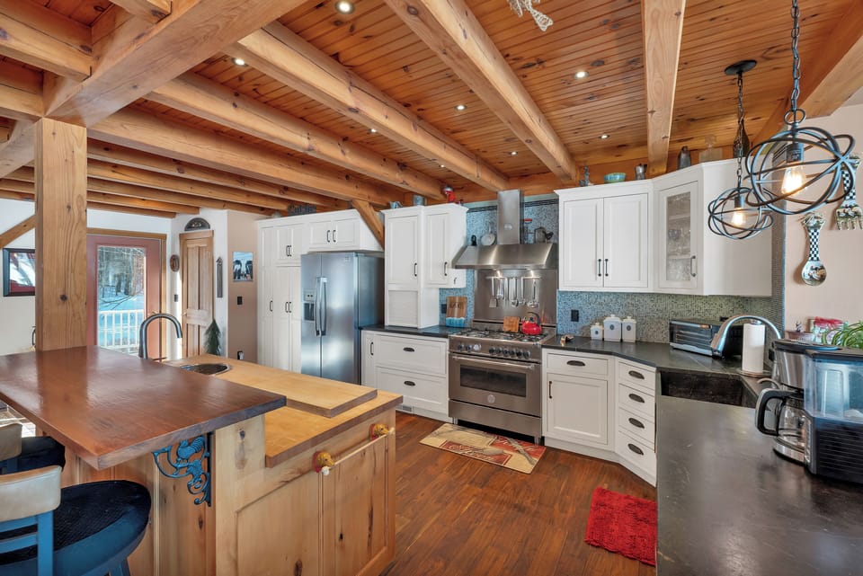 The beautiful kitchen has lake views and wonderful cooking amenities.