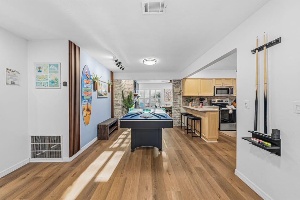 Spacious entertainment zone connecting the game area to the kitchen—great for social gatherings 