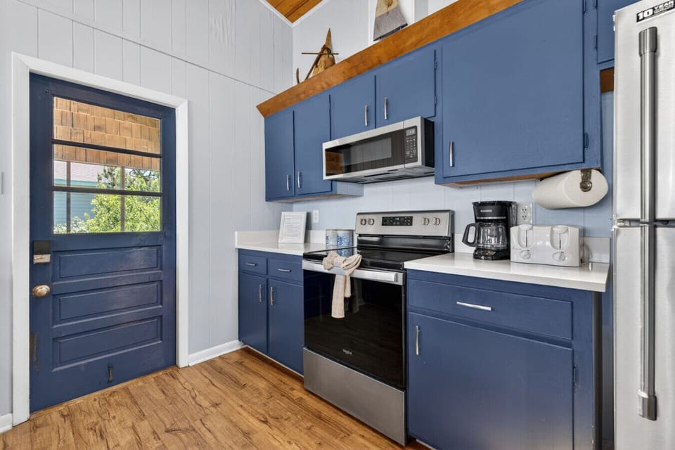 Beautifully updated with coastal charm, this fully equipped kitchen is ready for everything from pancake breakfasts to fresh seafood dinners.