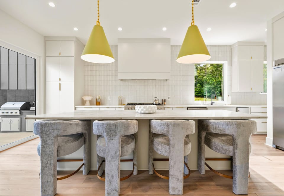 Gathering around the oversized kitchen island is easy with plenty of seating for meals, snacks, and conversations throughout the day.