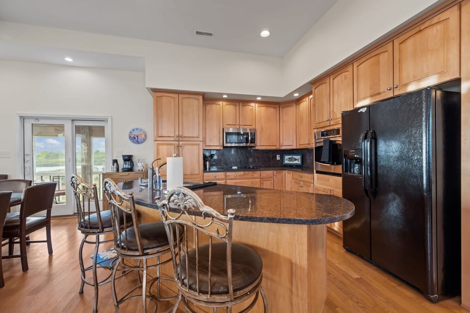 Fully equipped kitchen with spacious island seating—perfect for cooking, gathering, and entertaining your group
