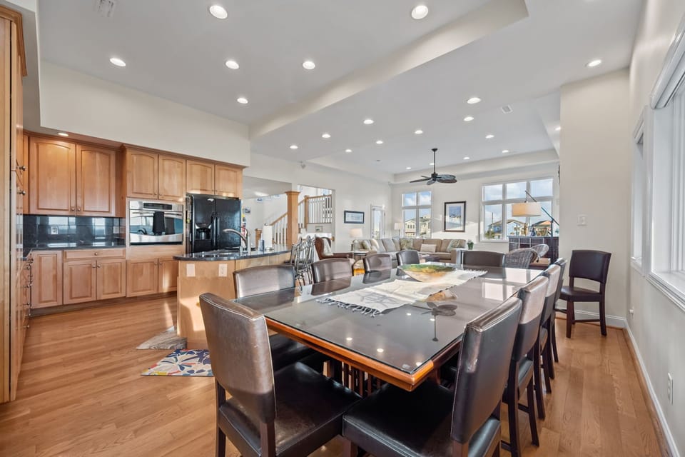 Large dining table with seating for the whole group, seamlessly connected to the kitchen and living area