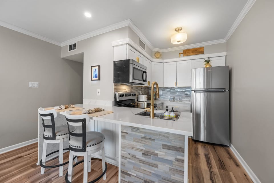 Bright, fully stocked kitchen with bar seating for easy mornings and meals