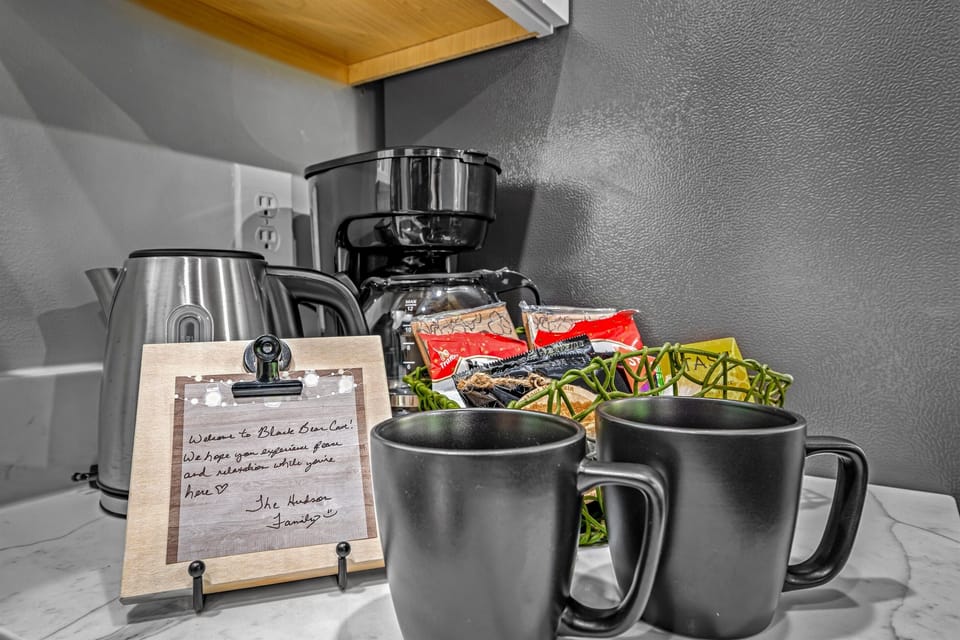 An electric hot water kettle and 12-cup drip coffee maker.