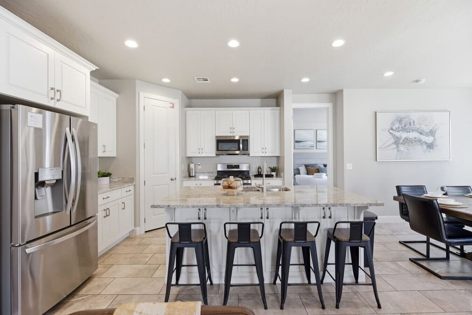 Kitchen Paradise: Sleek stainless steel appliances and stylish seating for culinary adventures!