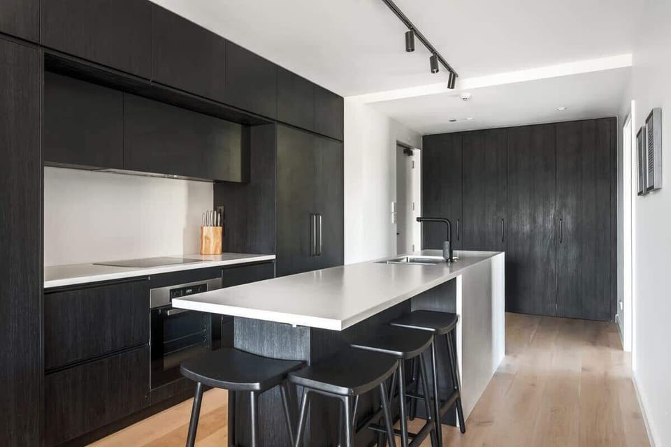 Modern kitchen, Clubhouse apartments Jacks Point. Luxury finishes, stone countertops, top appliances, Nespresso machine with complimentary pods, golf course & Remarkables views. Queenstown luxury stay.