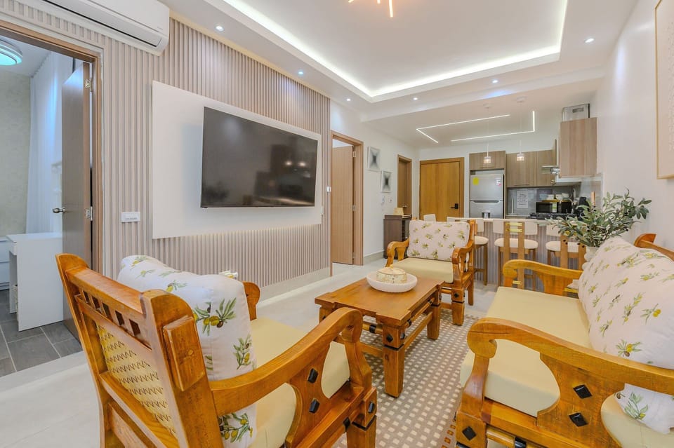 Comfort Apartment | Living area | 70-inch flat-screen TV with digital channels