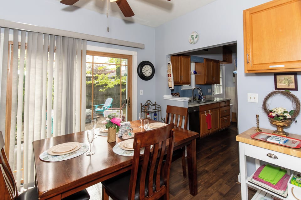 Bright dining space flowing into your fully-equipped kitchen, with patio doors opening to your private outdoor retreat—perfect for morning coffee or relaxed evening meals.