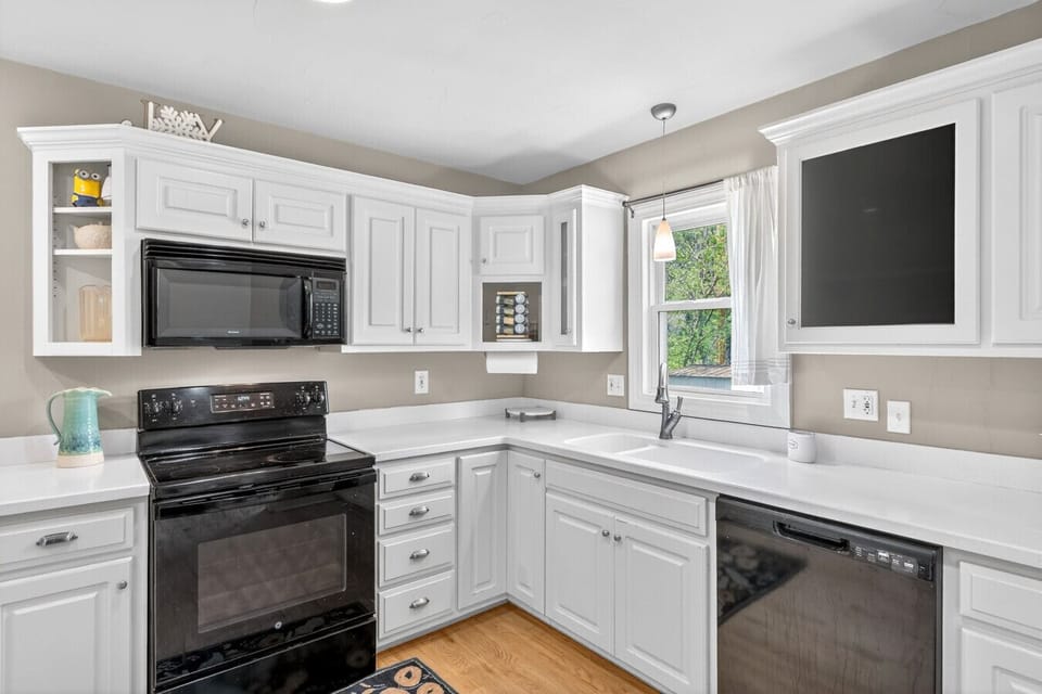 A well-designed kitchen corner with ample counter space, a double sink, and views of the yard.