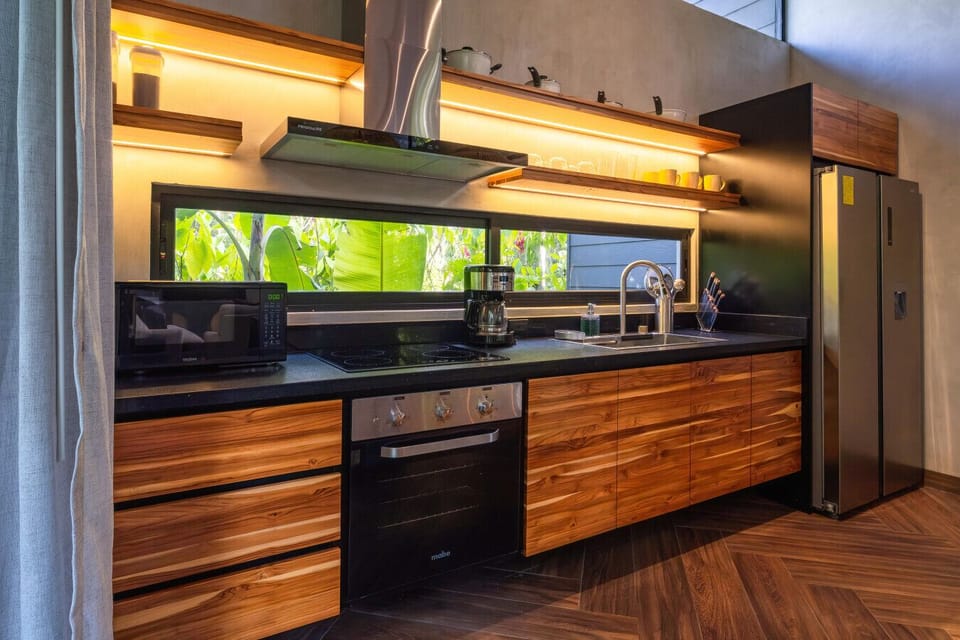 Fully equipped modern kitchen with natural light and jungle views, ideal for a comfortable stay in Punta Uva, Costa Rica.