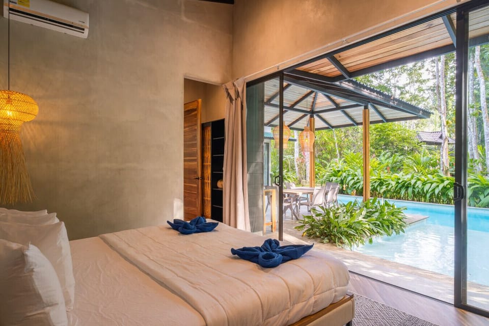 Bedroom with direct access to the pool area, surrounded by nature in a peaceful and private setting in Punta Uva.