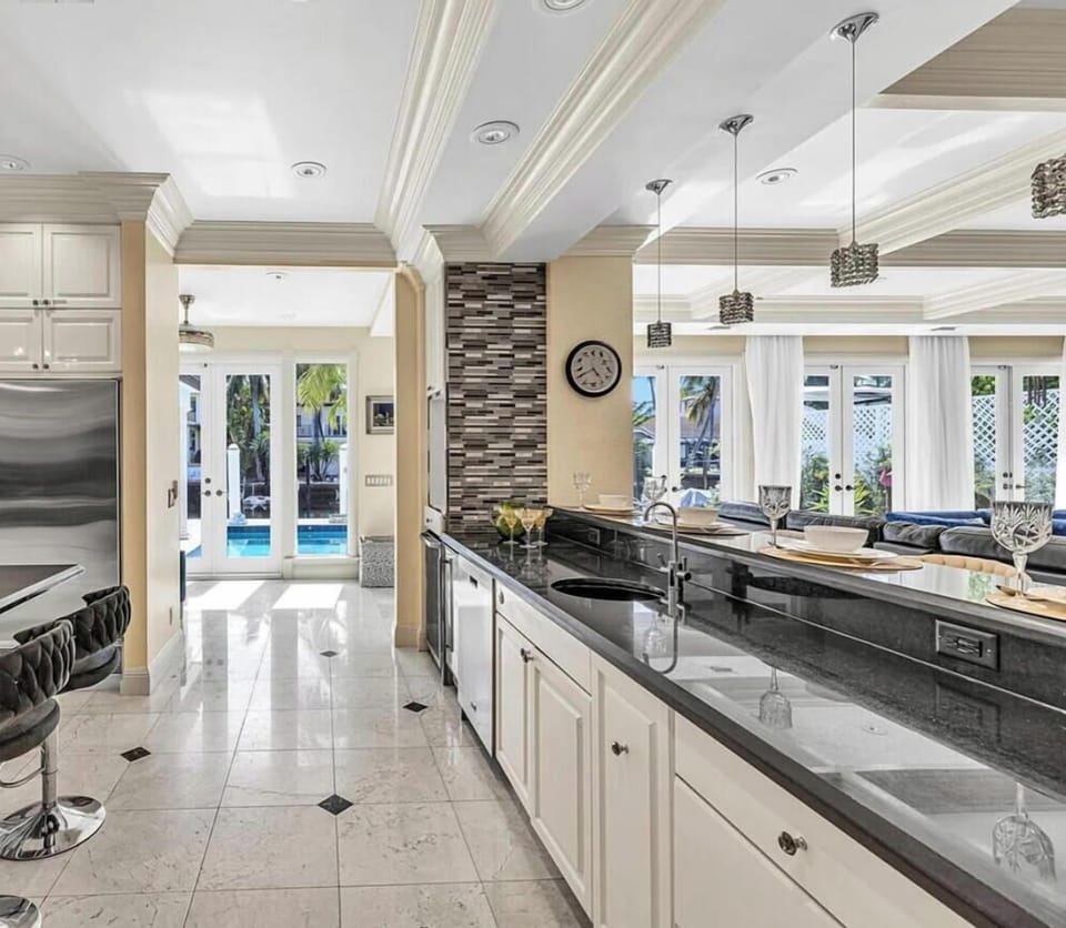Expansive open kitchen featuring ample counter space, a breakfast island and direct patio access