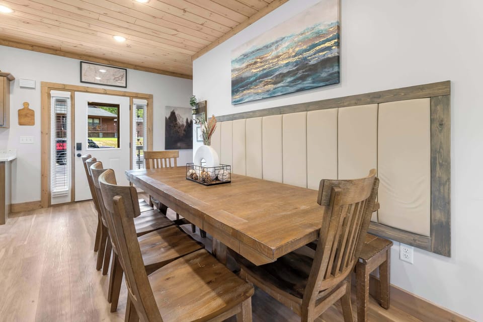 Spacious dining area with built-in bench seating, perfect for 10 guests.