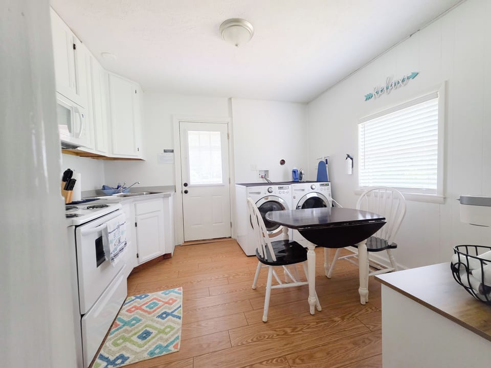 Washer & dryer located in the dining/kitchen area with coffee bar