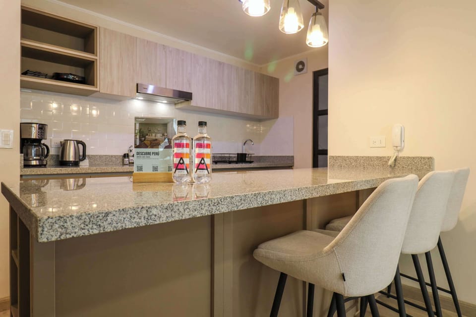 Modern kitchen with a stylish breakfast bar, perfect for casual meals or drinks.
