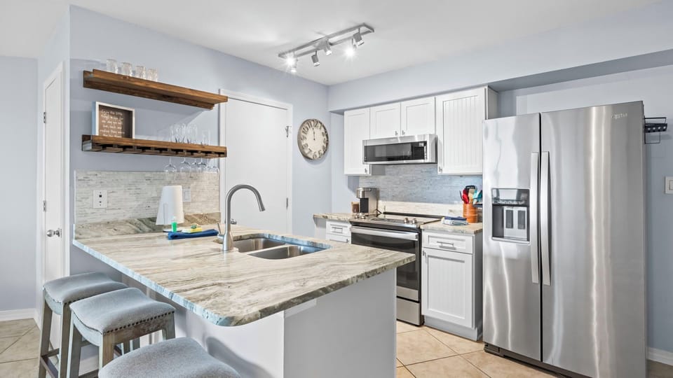 Modern kitchen with stainless steel appliances and a spacious breakfast bar.