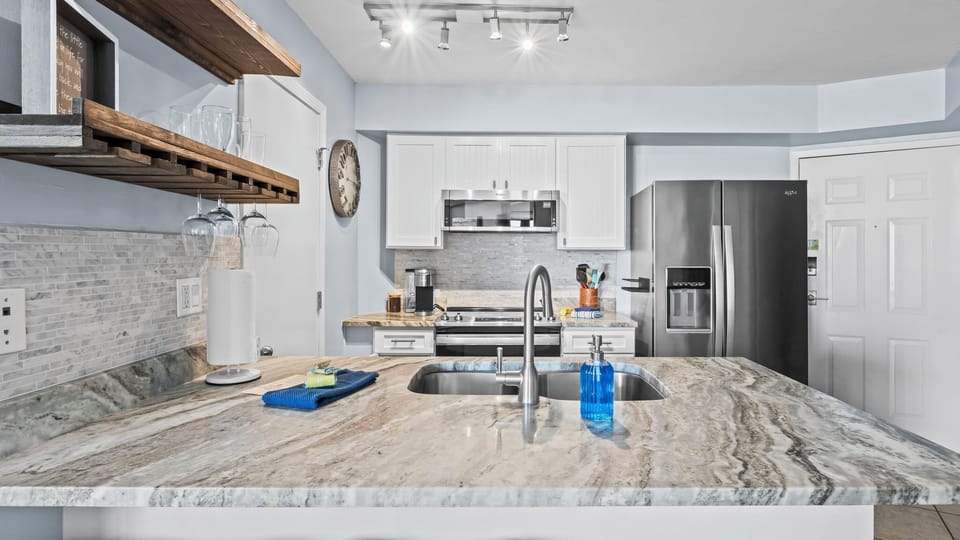 Modern kitchen with granite countertops and stainless steel appliances.