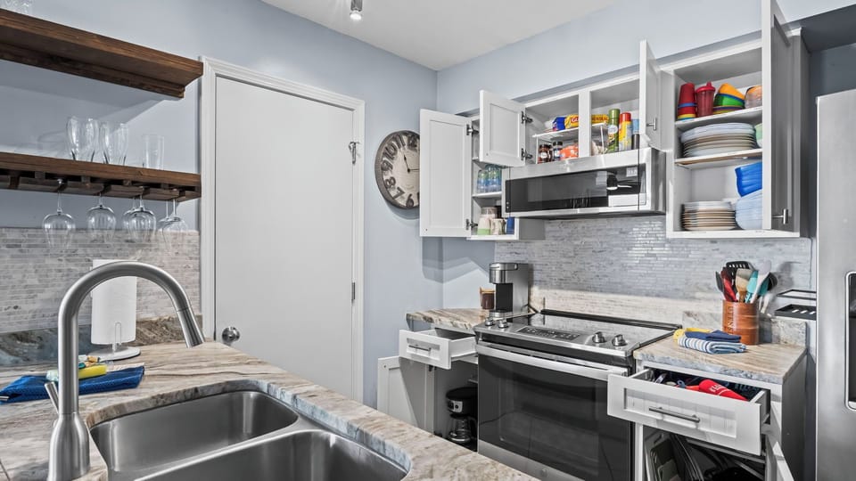 Fully equipped kitchen with ample cookware, dishes, and meal prep space.