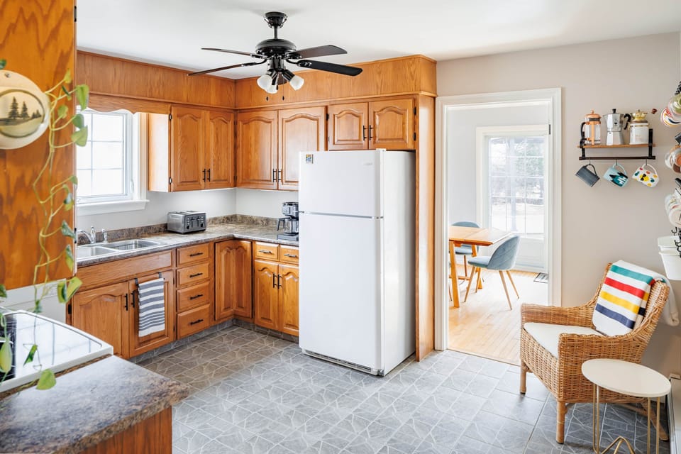 Bright, fully equipped kitchen with ample counter space and natural light.
